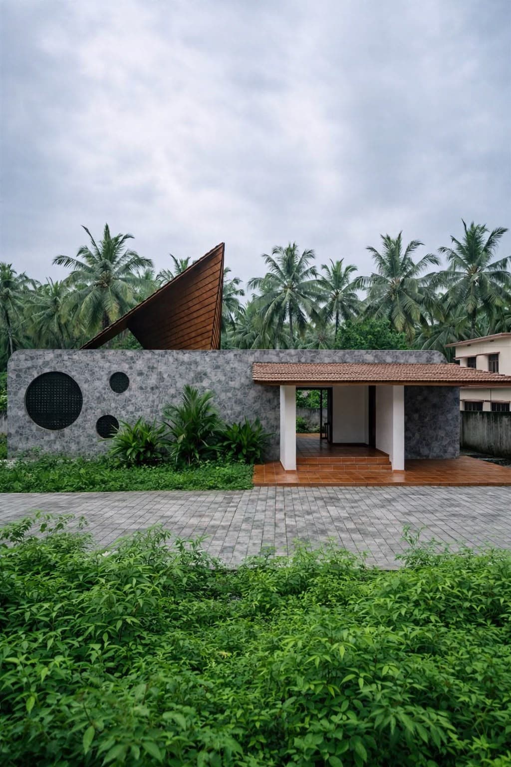 Kerala stone house with triangular roof by Elephant Studio Architects